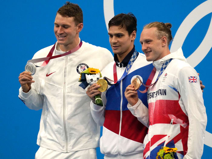 Ryan Murphy (USA), from left, Evgeny Rylov (ROC) and Luke Greenbank (GBR) pose with their medals after taking the top spots in the men's 200 backstroke final during the Tokyo 2020 Olympic Summer Games